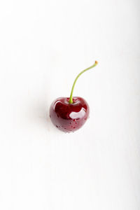 Close-up of strawberry on table against white background