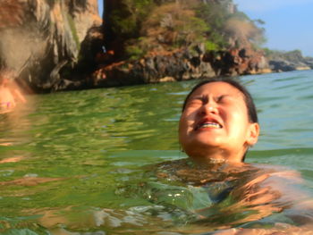 Portrait of smiling boy swimming in sea