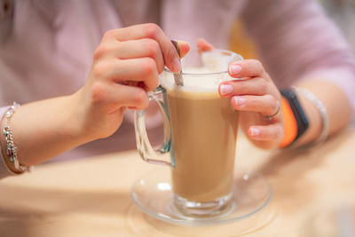 Midsection of woman having coffee