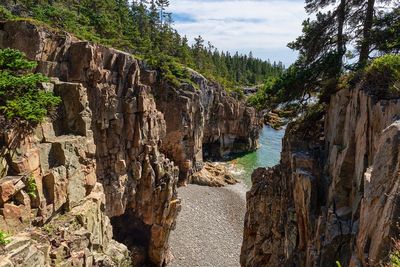 Panoramic view of rocks and trees against sky