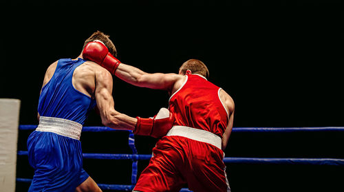 Boxers fighting in ring