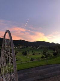 Scenic view of field against sky during sunset