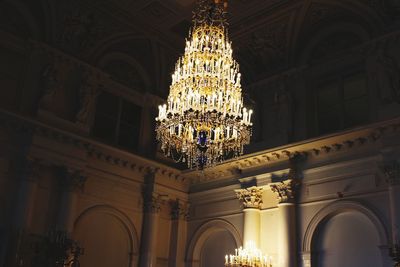 Low angle view of illuminated chandelier in church