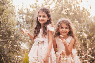 Two little girls playing in nature