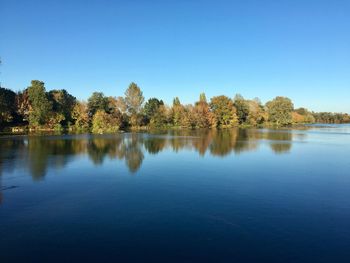 Scenic view of lake against clear blue sky