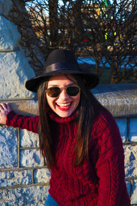 Portrait of smiling young woman wearing sunglasses outdoors