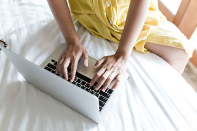 Midsection of woman using mobile phone