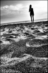 Silhouette of people walking on beach