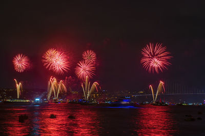 Low angle view of firework display at night