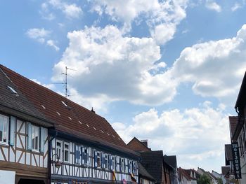 Low angle view of buildings in town against sky