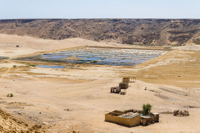 Scenic view of salt mining in desert against clear sky, mucuio, angola