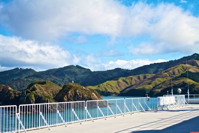 Scenic view of sea and mountains against sky