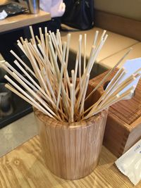 High angle view of sticks in wooden container on table