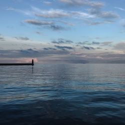 Scenic view of sea against cloudy sky