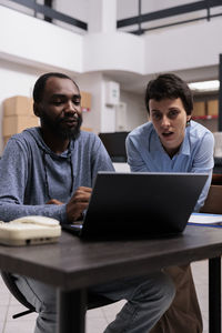 Senior man using laptop while sitting on table