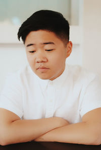 Close-up portrait of boy sitting at home