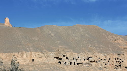 Panoramic view of castle on mountain against sky