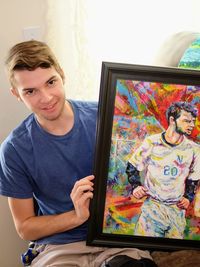 Portrait of young man sitting at home