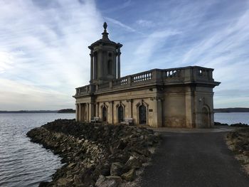 Castle by sea against sky