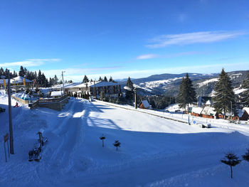 Scenic view of snow covered mountain against blue sky