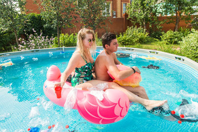 Woman sitting in swimming pool