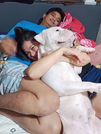 Happy friends lying on bed