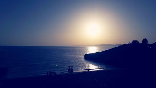 Scenic view of sea against clear sky during sunset