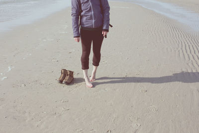 Low section of woman standing on beach