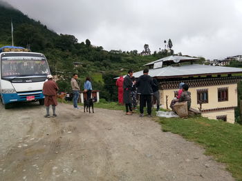 People walking on road against sky