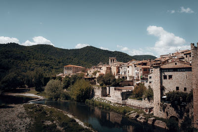 Townscape with river against sky