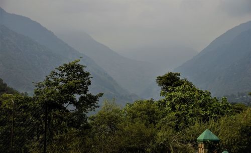 Scenic view of tree mountains against sky