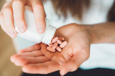 Close-up of hand holding pills