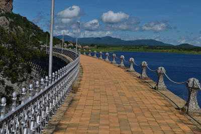 View of pier on sea against cloudy sky