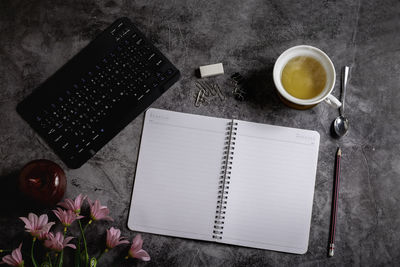 High angle view of coffee and book on table