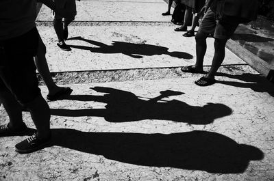 Low section of people standing on tiled floor