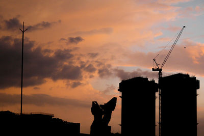 Silhouette of building structure against sky during sunset