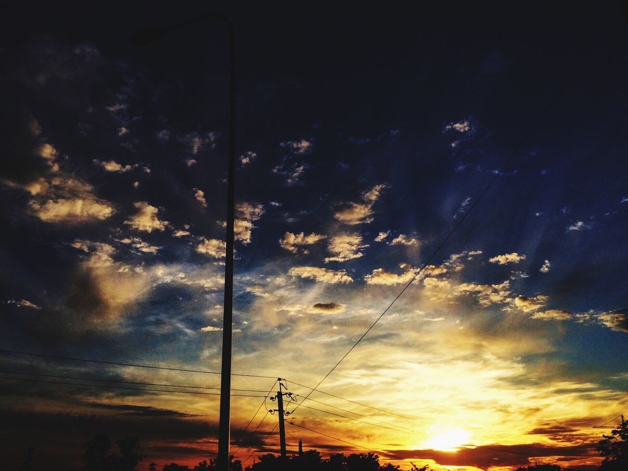 LOW ANGLE VIEW OF SILHOUETTE ELECTRICITY PYLON AGAINST SKY AT SUNSET