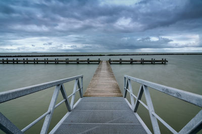 Pier over sea against sky