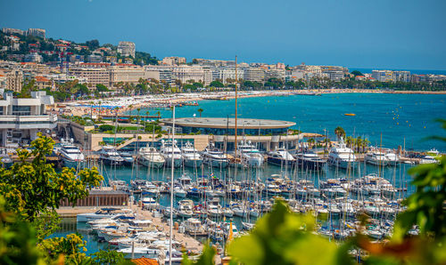 High angle view of buildings by sea against clear sky