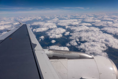 Aerial view of aircraft wing against sky