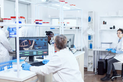 Rear view of scientist working in laboratory