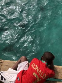 Rear view of men relaxing in swimming pool