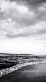 Scenic view of sea against storm clouds