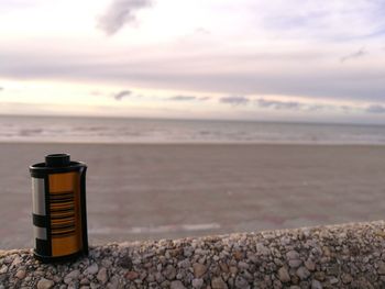 Metal container on stone wall at beach