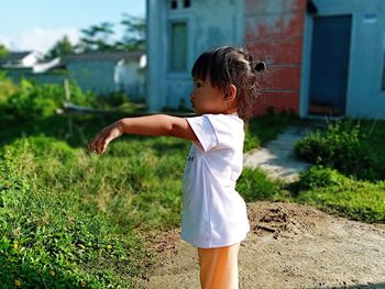 Side view of woman standing on field