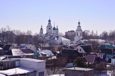 Buildings in city against clear sky