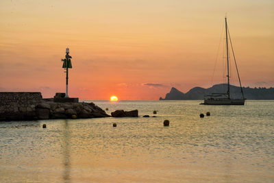 Scenic view of sea against orange sky