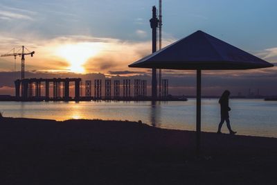 Pier on sea at sunset