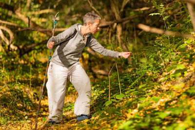 Mindfulness in motion. mindful middle-aged woman exploring the forest in the fall