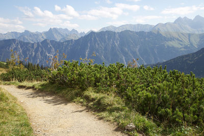 Scenic view of mountain range against cloudy sky